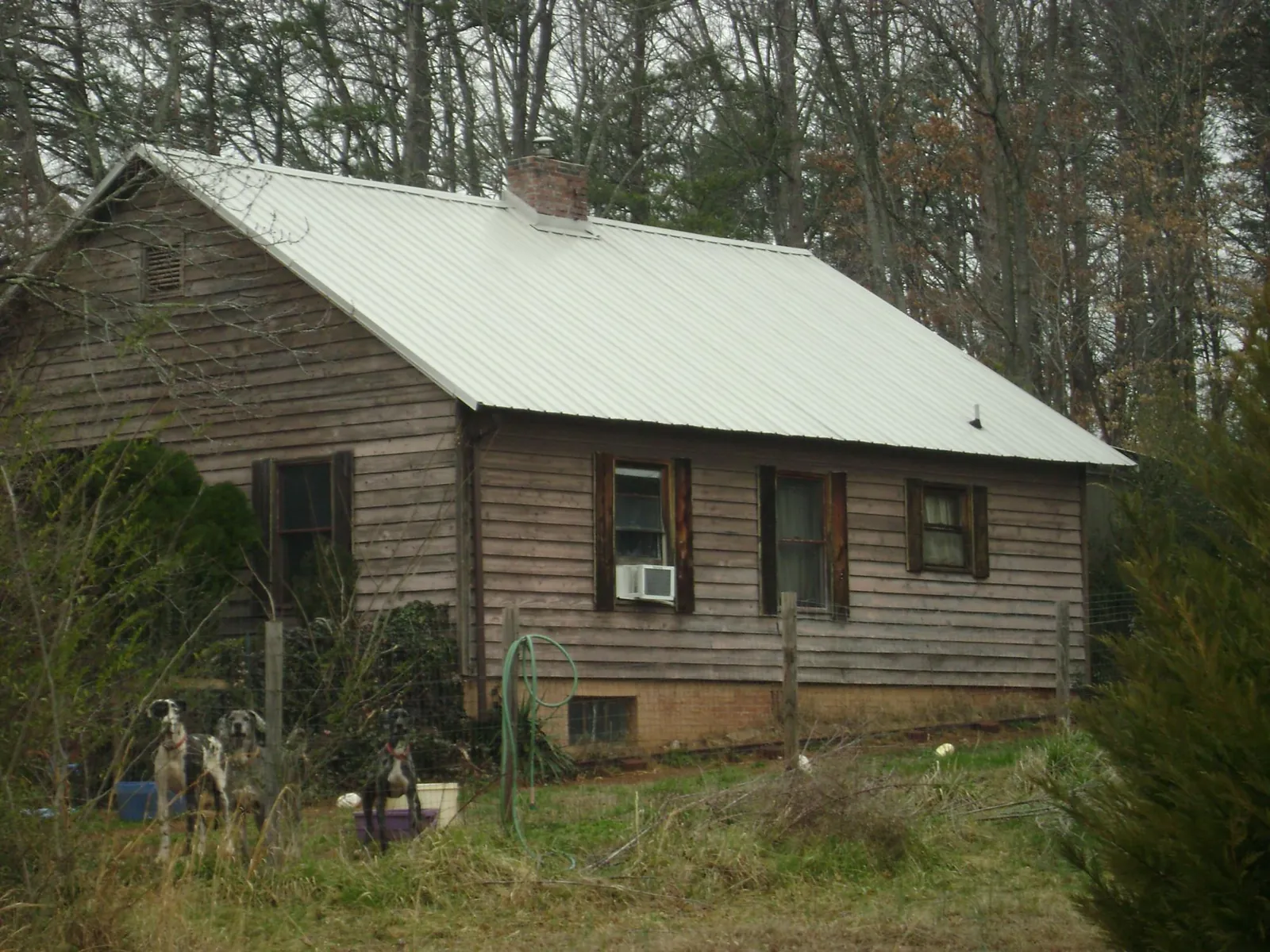 White metal roof on an old wood sided farmhouse, from a Metal Roof Installation job in Boone
